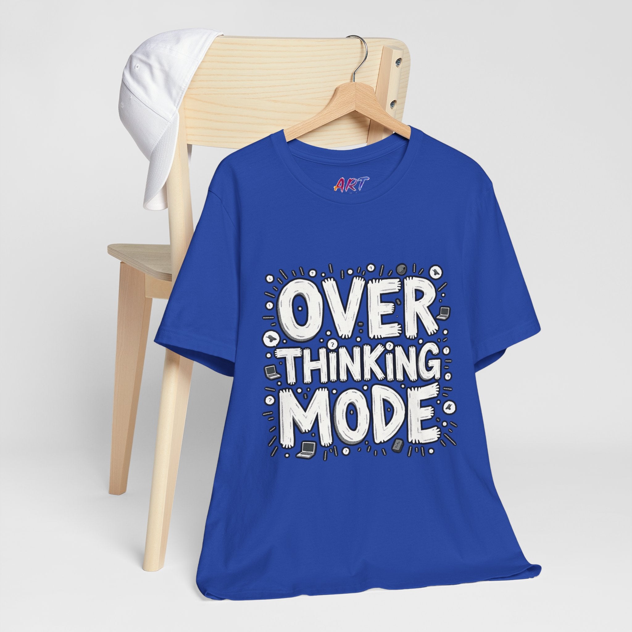 White hand-drawn typography saying Overthinking Mode with laptop and book doodles on a dark premium t-shirt.