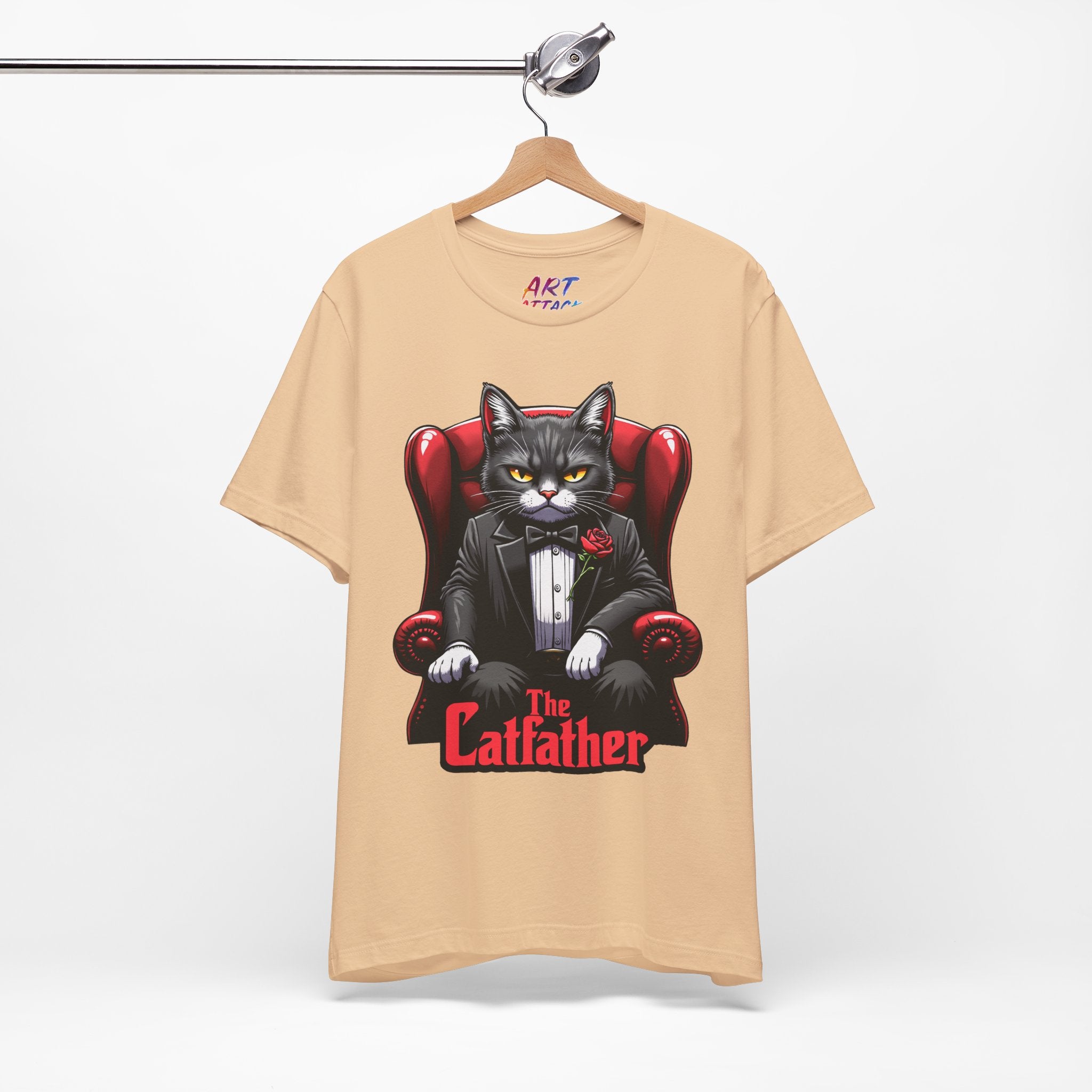 A serious grey cat dressed in a black tuxedo with a red rose on the lapel, sitting like a mafia boss in a red leather armchair with the text The Catfather below.