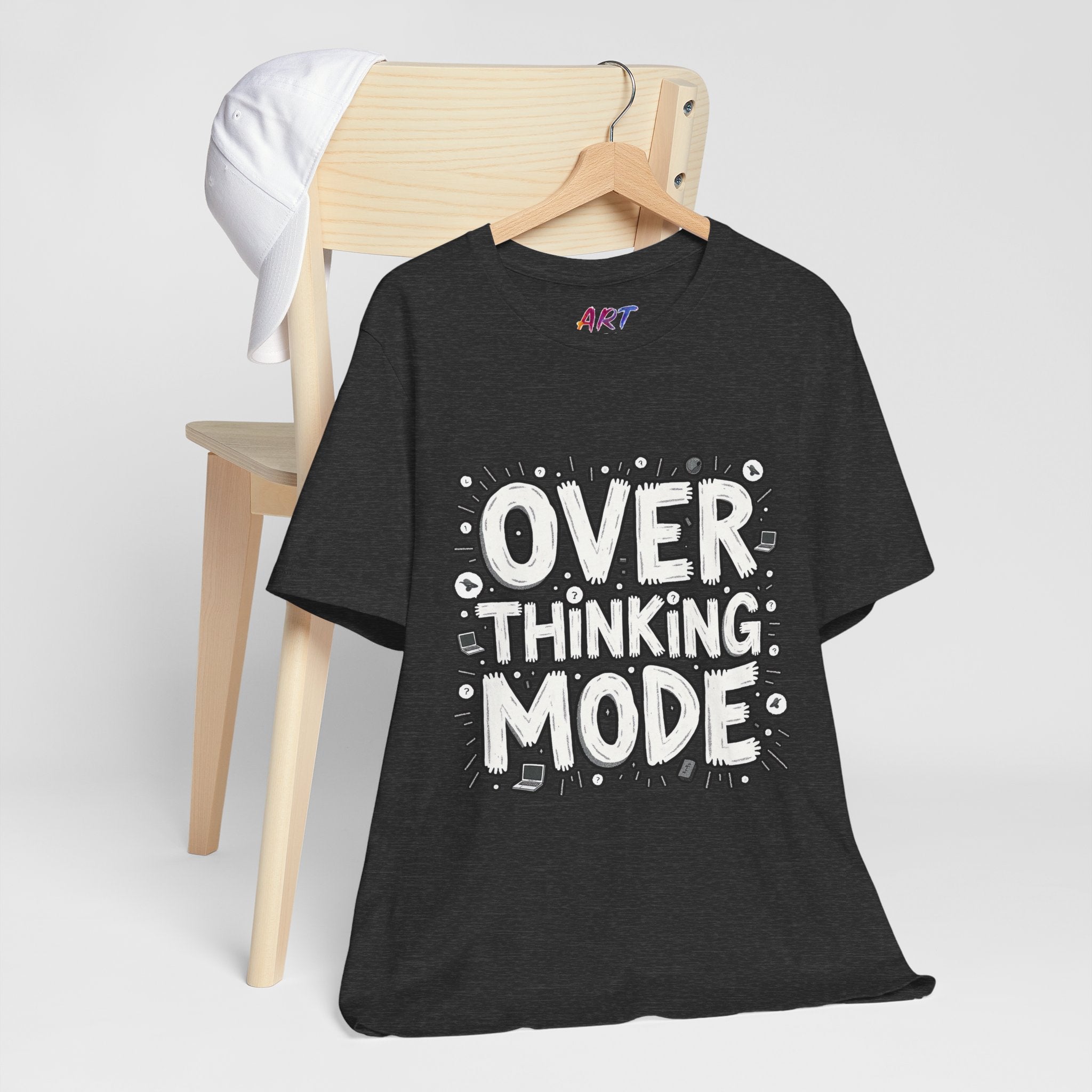 White hand-drawn typography saying Overthinking Mode with laptop and book doodles on a dark premium t-shirt.