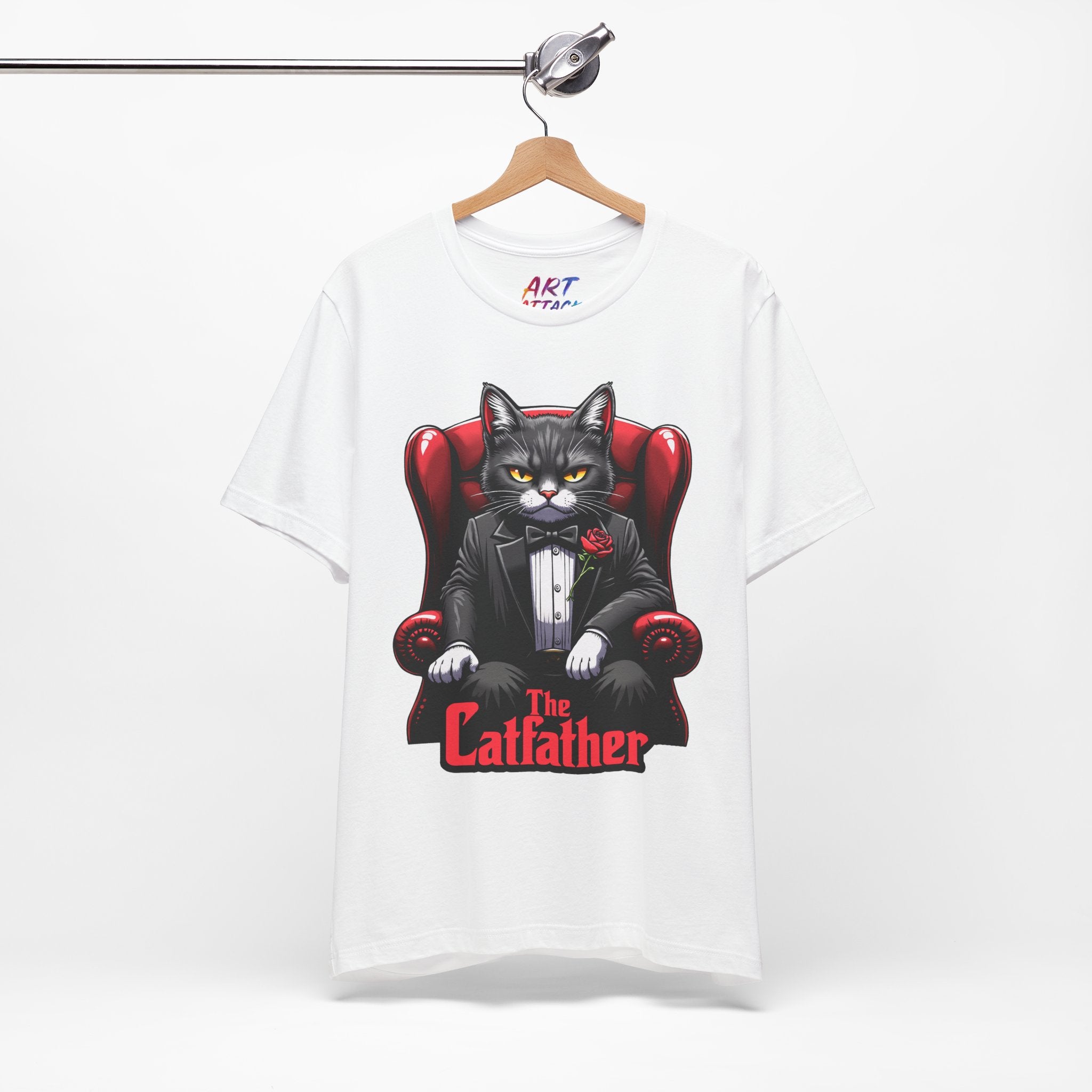 A serious grey cat dressed in a black tuxedo with a red rose on the lapel, sitting like a mafia boss in a red leather armchair with the text The Catfather below.