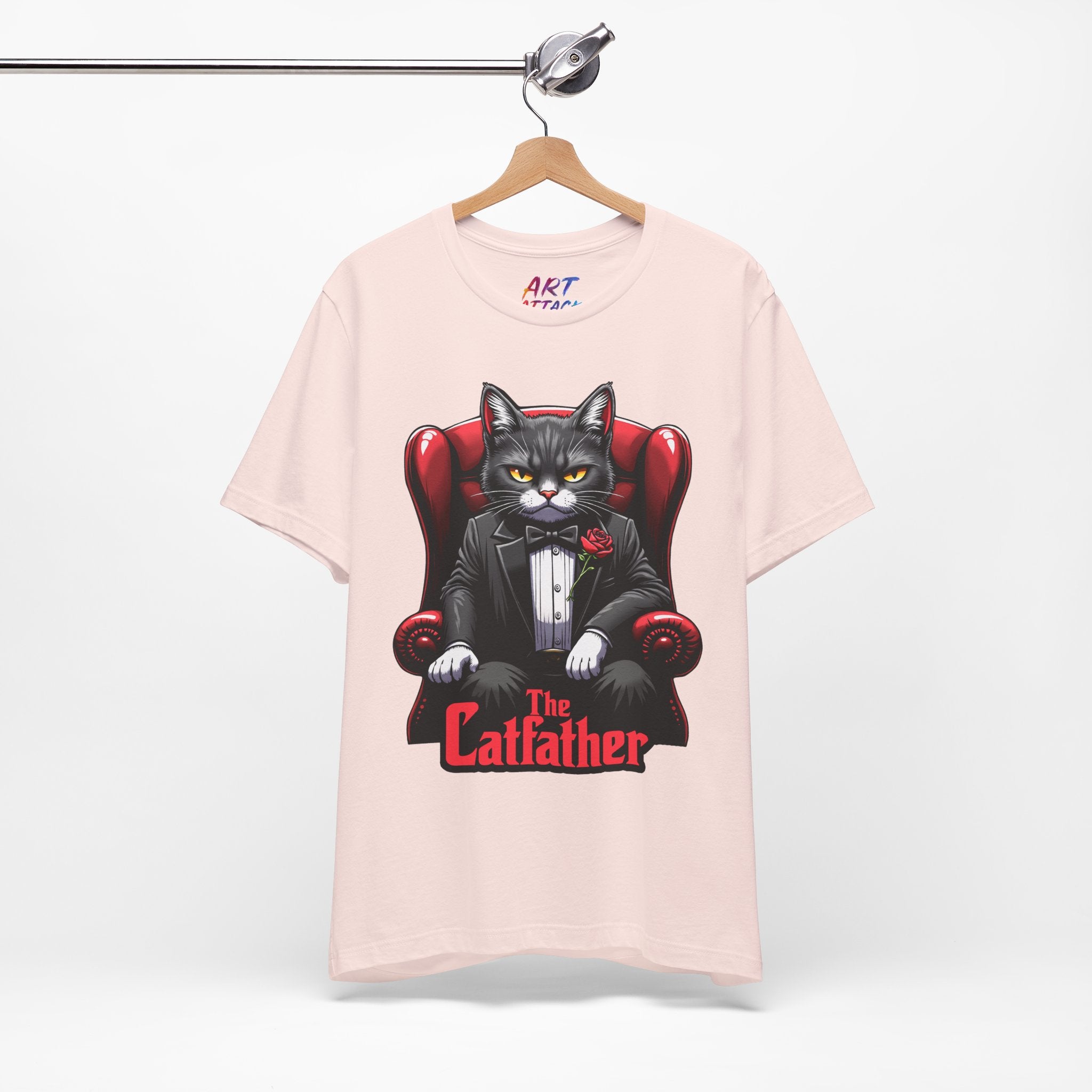 A serious grey cat dressed in a black tuxedo with a red rose on the lapel, sitting like a mafia boss in a red leather armchair with the text The Catfather below.
