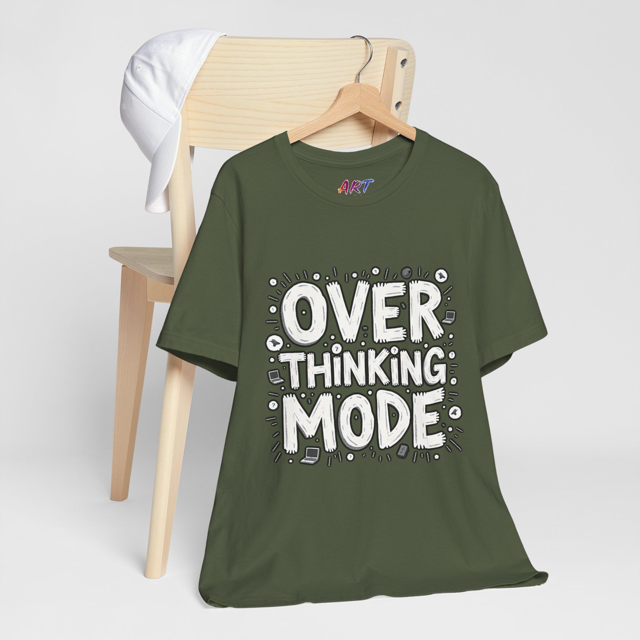 White hand-drawn typography saying Overthinking Mode with laptop and book doodles on a dark premium t-shirt.