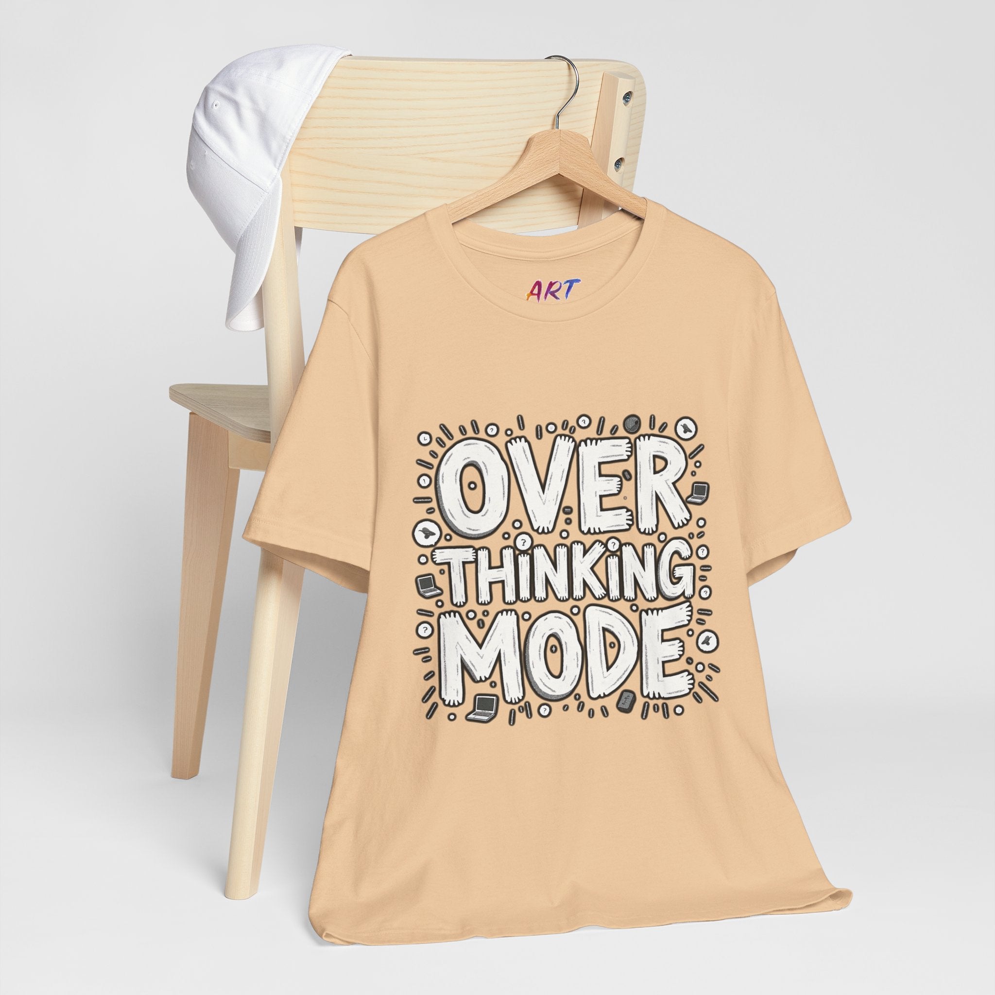 White hand-drawn typography saying Overthinking Mode with laptop and book doodles on a dark premium t-shirt.