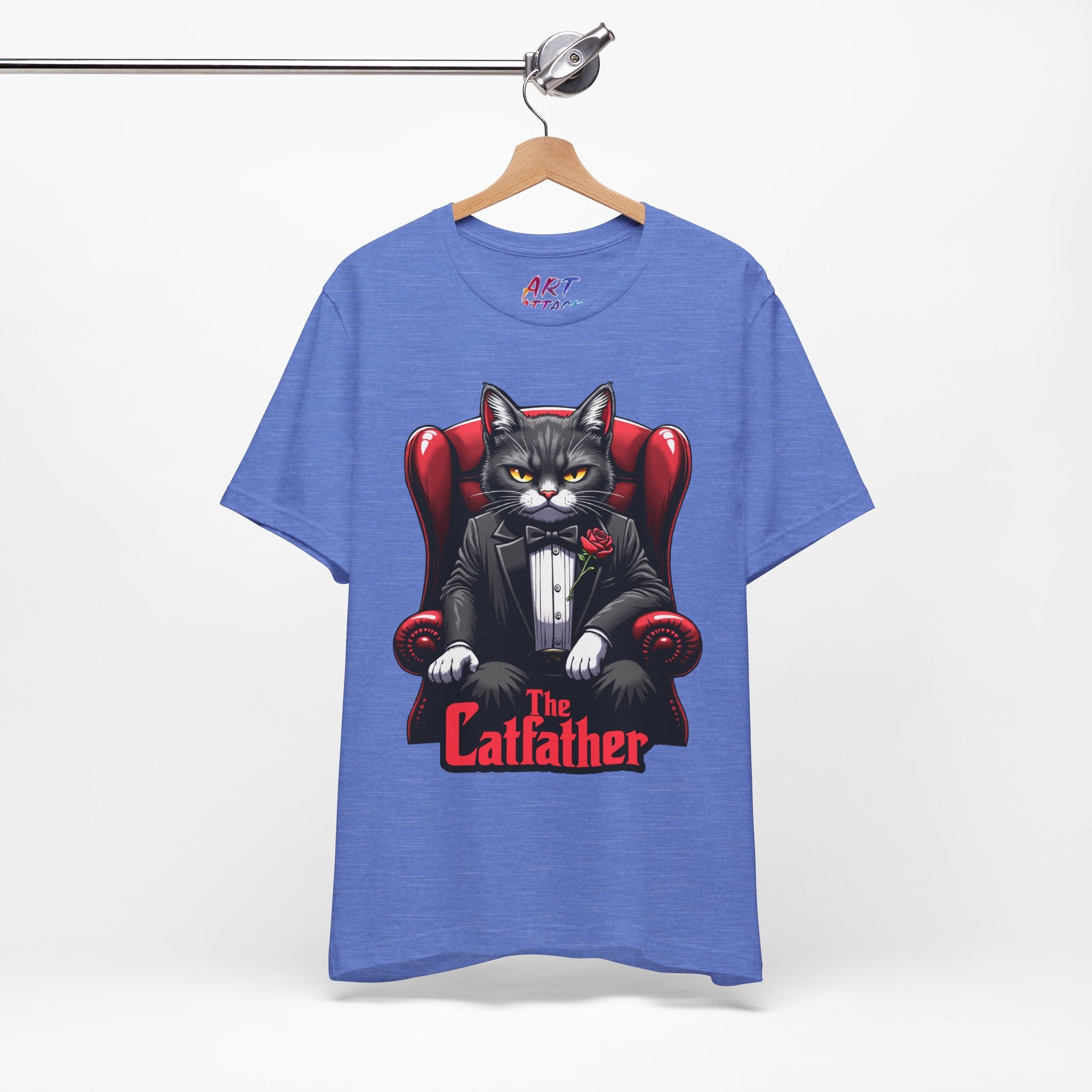 A serious grey cat dressed in a black tuxedo with a red rose on the lapel, sitting like a mafia boss in a red leather armchair with the text The Catfather below.