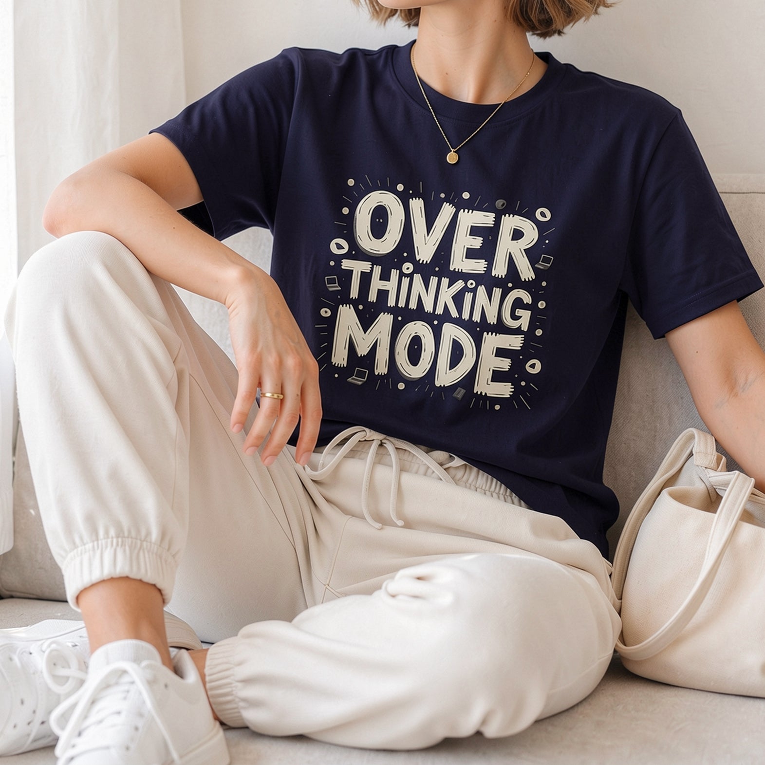White hand-drawn typography saying Overthinking Mode with laptop and book doodles on a dark premium t-shirt.