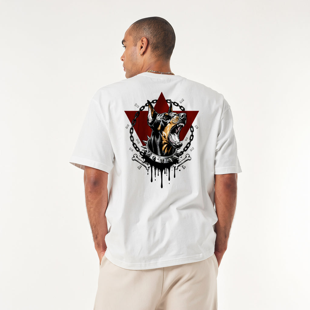 oversized streetwear t-shirt. Front shows the word UNTAMED in red dripping text. Back features an aggressive Doberman dog with a spiked collar, chains, bones, and a red triangle background.